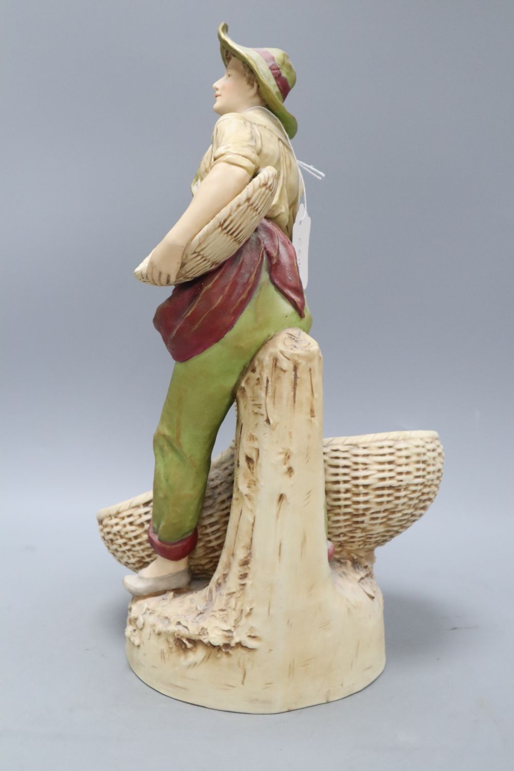 A Royal Dux figure of a boy carrying baskets, height 40cm